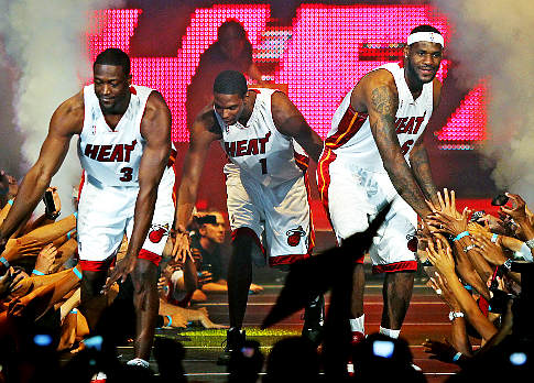 Dwyane Wade, left, Chris Bosh, center, and LeBron James, right ,greet fans during an event at the American Airlines Arena in Miami Friday, July 9, 2010. (AP Photo/Miami Herald, Al Diaz) ** KEY WEST OUT. MAGS OUT, TV OUT. NO SALES **   Original Filename: LeBrons_Decision_Basketball_FLMIH102.jpg
